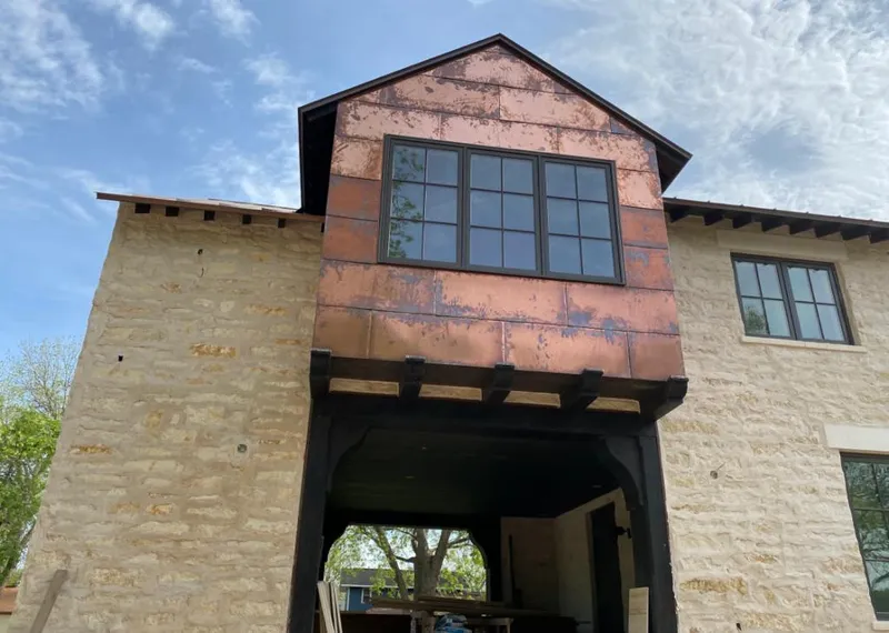 Copper metal panel facade on a stone building for Metal Roof Coating in La Marque